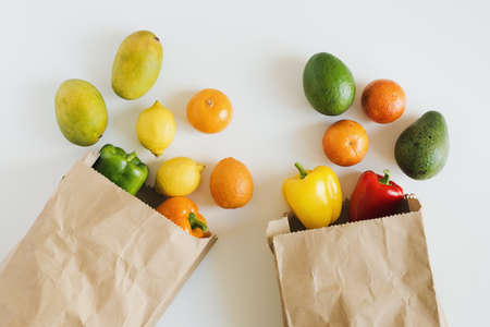 Local fruits and vegetables delivered in brown eco friendly paper bags, top view. Grocery delivery servicesの写真素材