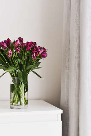 Fresh Alstroemeria flowers bouquet in a glass transparent vaseの写真素材