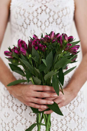 Woman holding Alstroemeria flowers bouquet. Simple bridal boquetの写真素材
