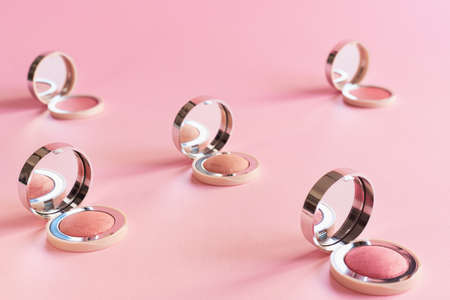 Blush powder collection of various color on pink background. Makeup decorative cosmetics and beauty productsの写真素材