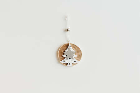 One wooden Christmas tree ornament on a white background. Eco friendly Christmas decorの写真素材