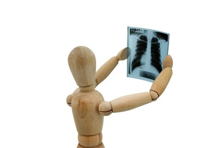 Wooden man looking at x-ray on the white background