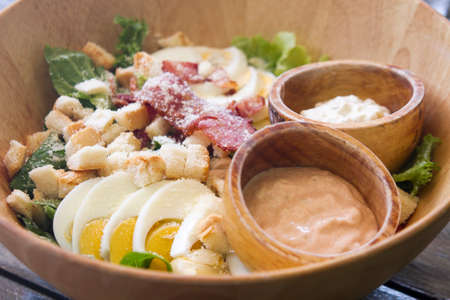 Caesar salad on the garden tableの写真素材