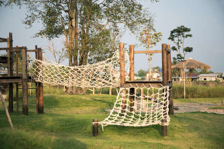 Nets and wooden swings in the playgroundの写真素材