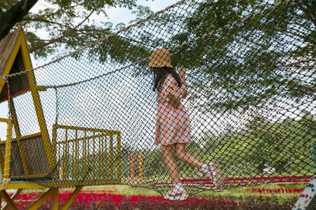 asian child girl climbing in the playgroundの写真素材