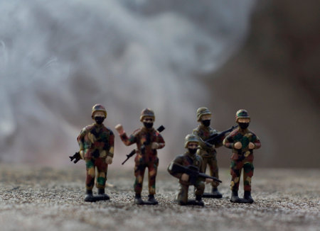 Miniature toy soldiers with guns and smoke. Selective focus.の写真素材