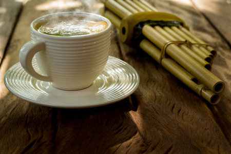 hot coffee in cup on old wood backgroundの写真素材