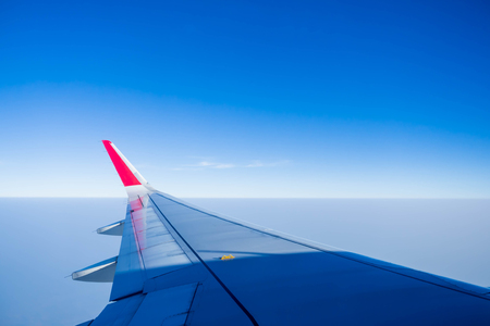 Wing of the plane on blue sky.の写真素材