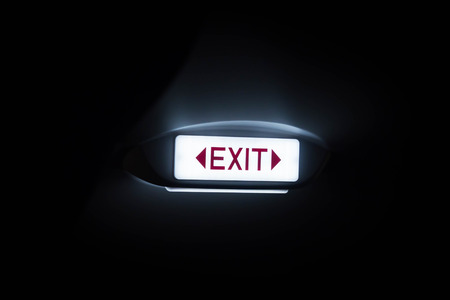 Exit sign on black background on plane.の写真素材