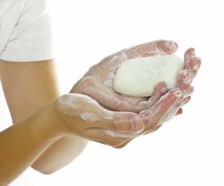 hands and soap on white background