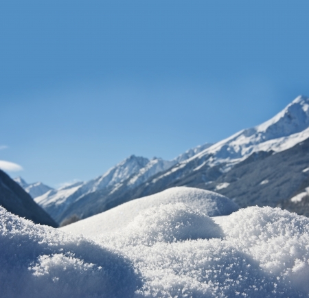 winter background with snow texture close up and mountains backgroundの写真素材