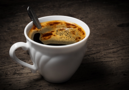 a cup of coffee on an old wooden table - vintade styleの写真素材