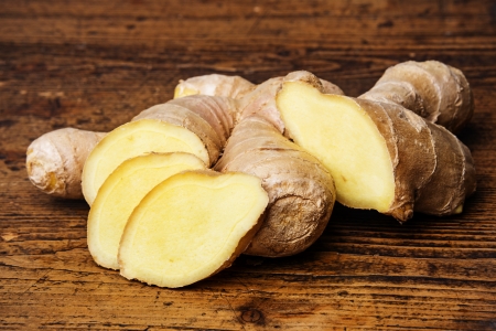 raw ginger on a wooden background