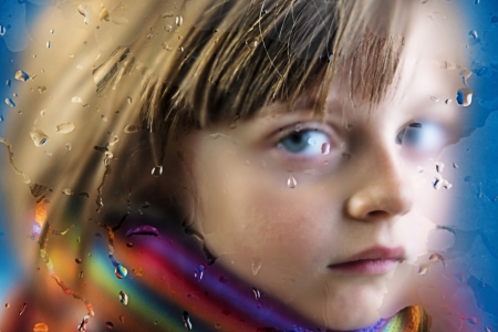 rainy - portrait of a  little girl behind a dewy windowの写真素材