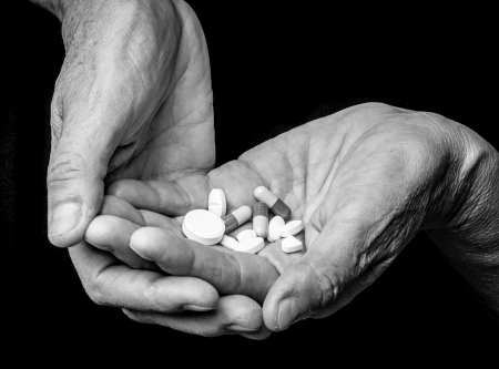 old hands with pillsの写真素材