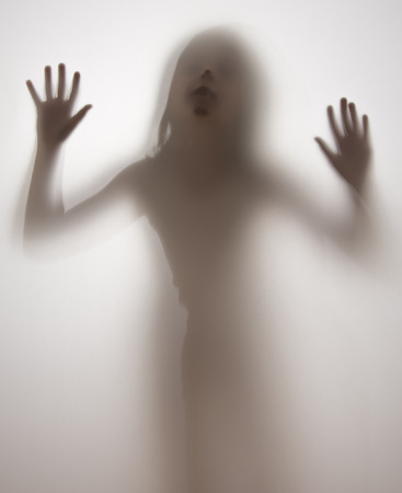 shadow of a girl behind transparent paperの写真素材