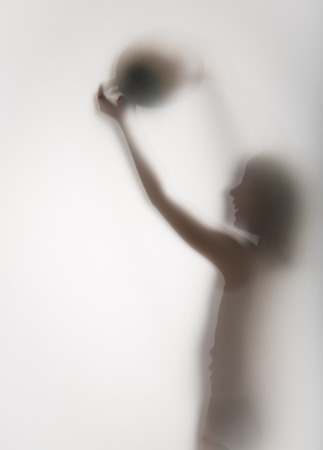 shadow of a girl behind transparent paperの写真素材