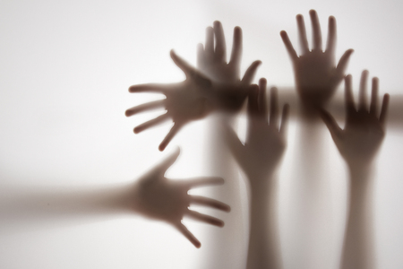 shadow of a hands behind transparent paperの写真素材