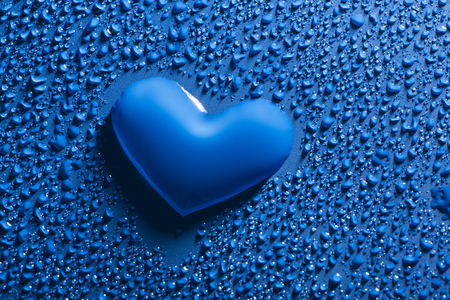 a heart shape between blue water drops - love conceptの写真素材