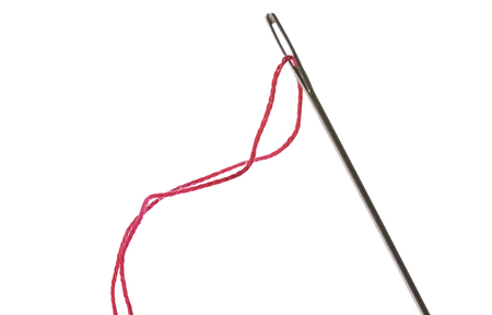 red thread in eye of silver needle