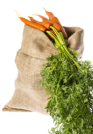 a sack with carrot isolated on a whiteの写真素材