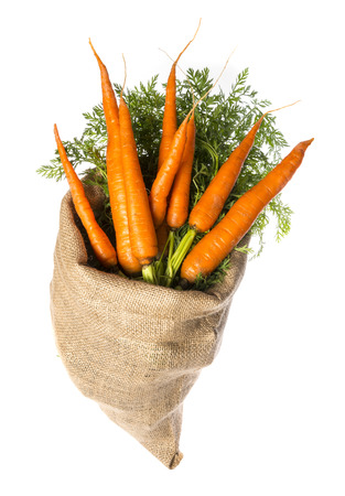 a sack with carrot isolated on a whiteの写真素材