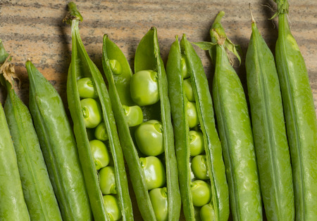 green pea on old wooden table close up