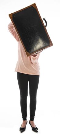 young girl with an old suitcase isolated on a white background
