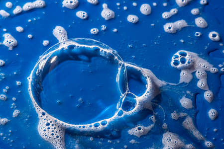 soap foam on a blue background - macro photographyの写真素材