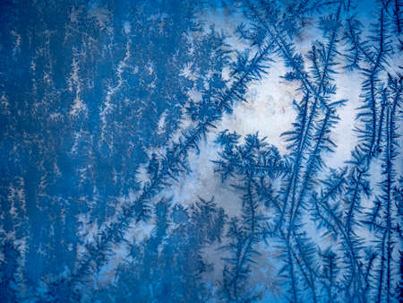 Ice crystals in the detail on a window glass in winter time