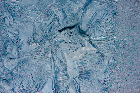 Ice crystals in the detail on a window glass in winter time
