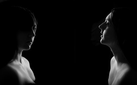 face of girl on a dark background with a back lightの写真素材