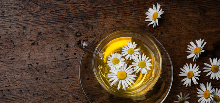 fresh chamomile tea on an old wooden tableの写真素材