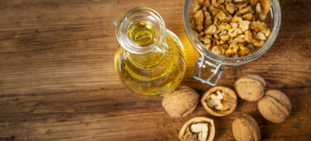 fresh walnuts and oil on an old wooden tableの写真素材