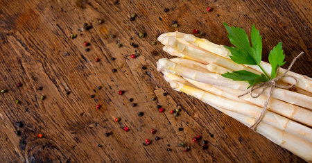 and white asparagus on wooden tableの写真素材