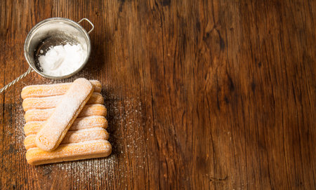 sponge biscuit - ladyfinger savoiardi on a wooden tableの写真素材