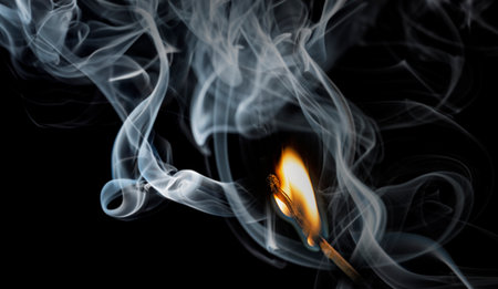 a match with fire and smokeの写真素材