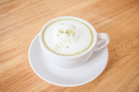 green tea latte on wood tableの写真素材