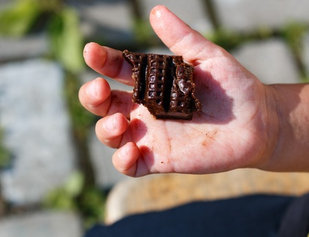 little girl holding a chocolate.