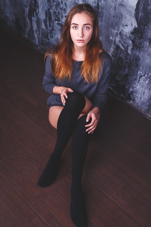 young sexy girl in a stylish jacket is sitting.の写真素材