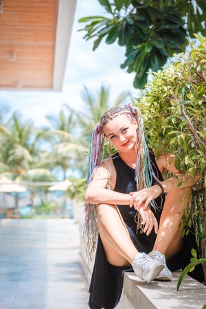 beautiful girl with pigtails on the stairs.の写真素材