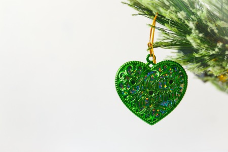 Christmas toy in the shape of a heart hanging on a Christmas treeの写真素材