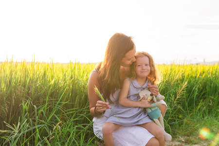Young Mother and daugther Hug near rice field, nature, travel.の写真素材