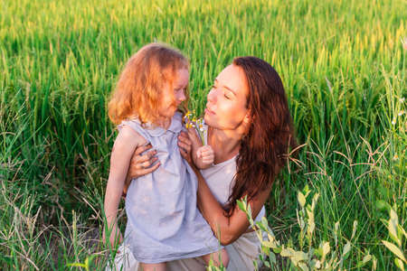 Young Mother and daugther Hug near rice field, nature, travel.の写真素材