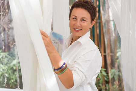 business woman smile and holds on to the neck