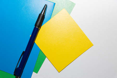 School accessories on a White table, sheet of paper and pencilsの写真素材