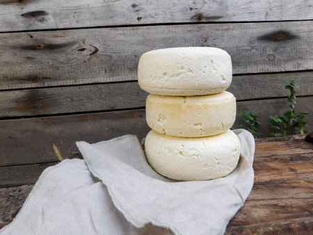 Homemade cheese on the background of wooden wall