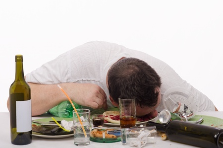 Drunk man put his head in a plate