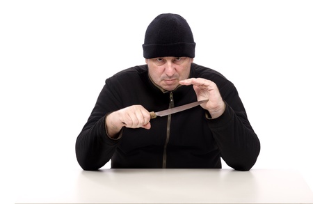 Murderer in black clothes with kitchen knifeの写真素材