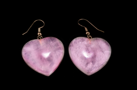Pair rose quartz ear hearts on black backgroundの写真素材